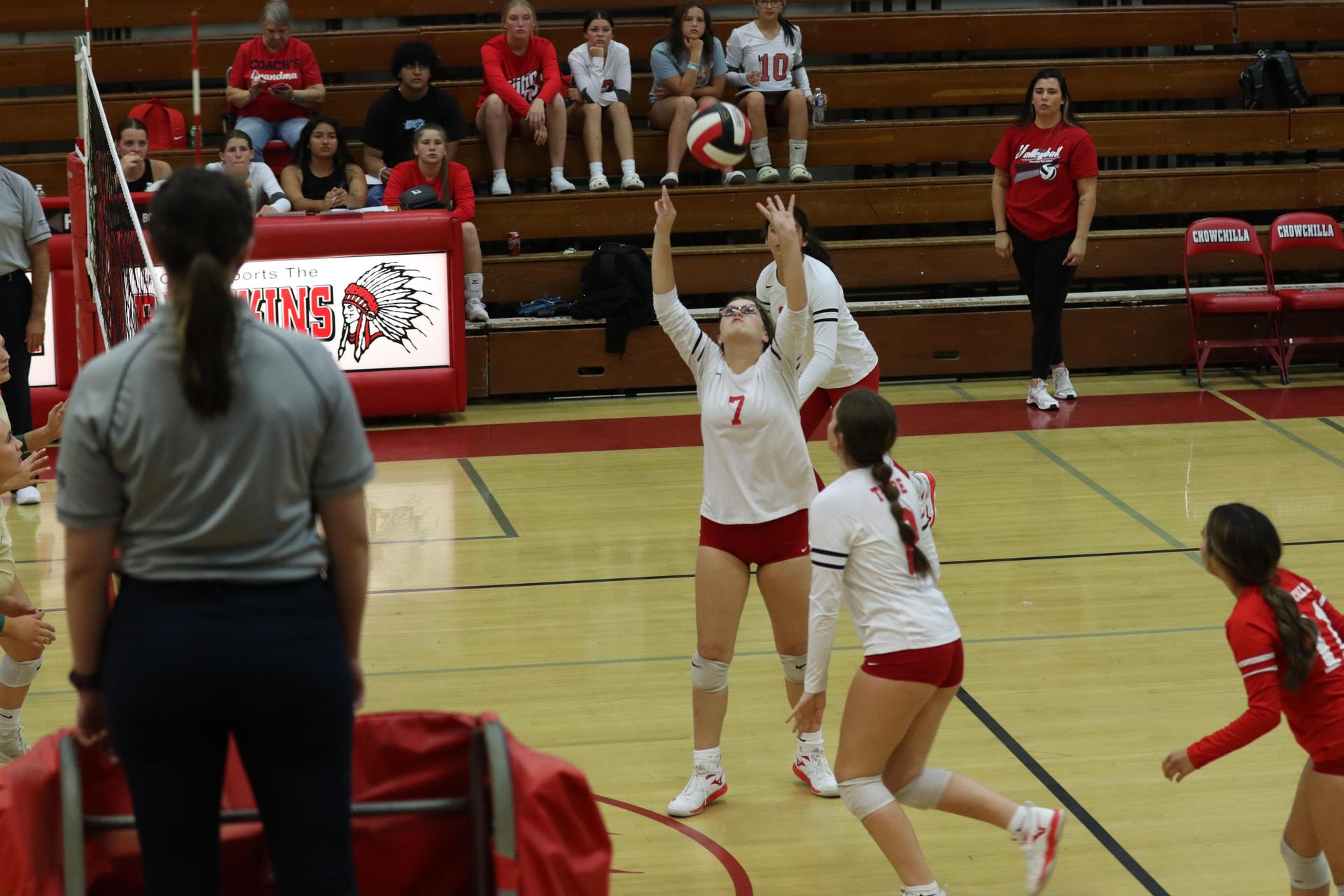 varsity volleyball players in action against liberty