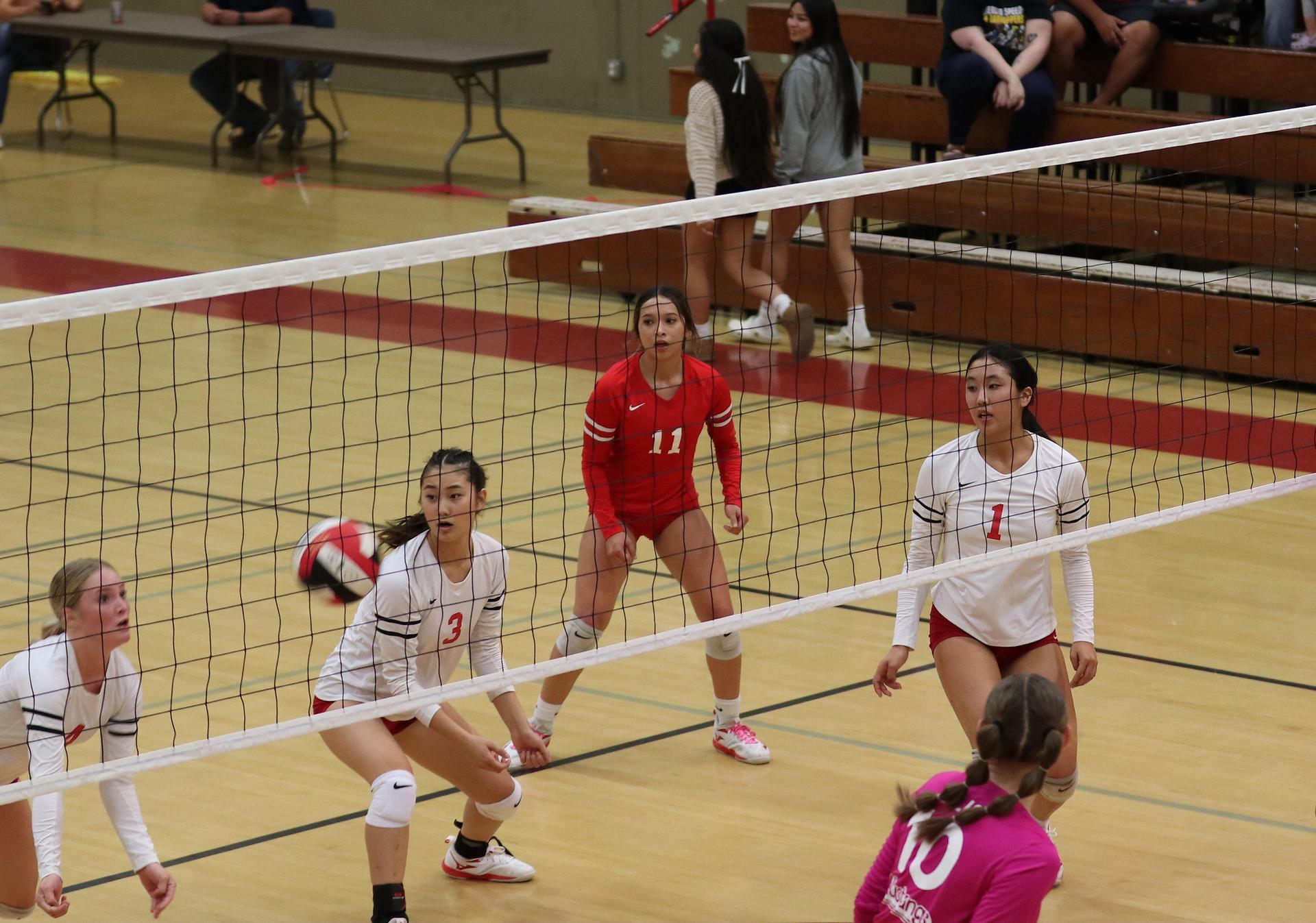 varsity volleyball players in action against Minarets
