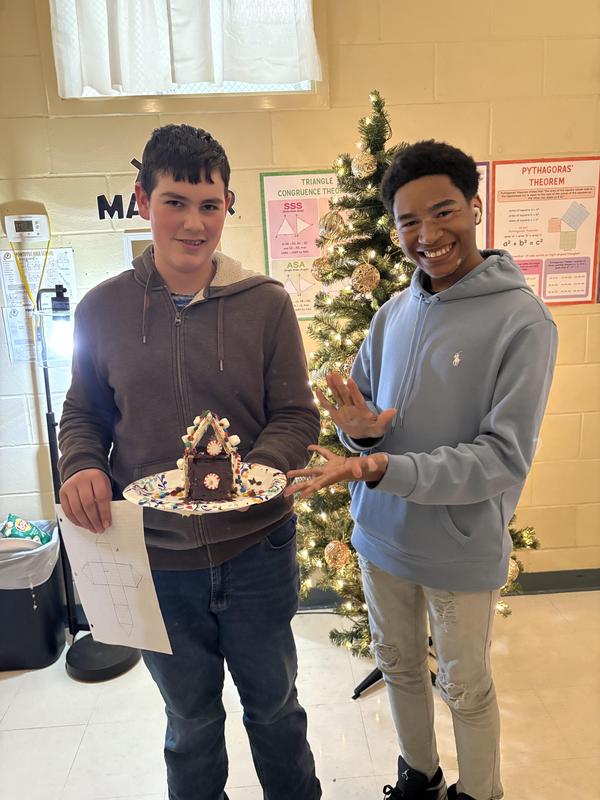 two students with gingerbread house