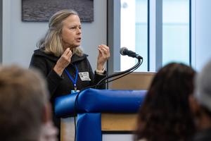 Martha Rial talks at a podium