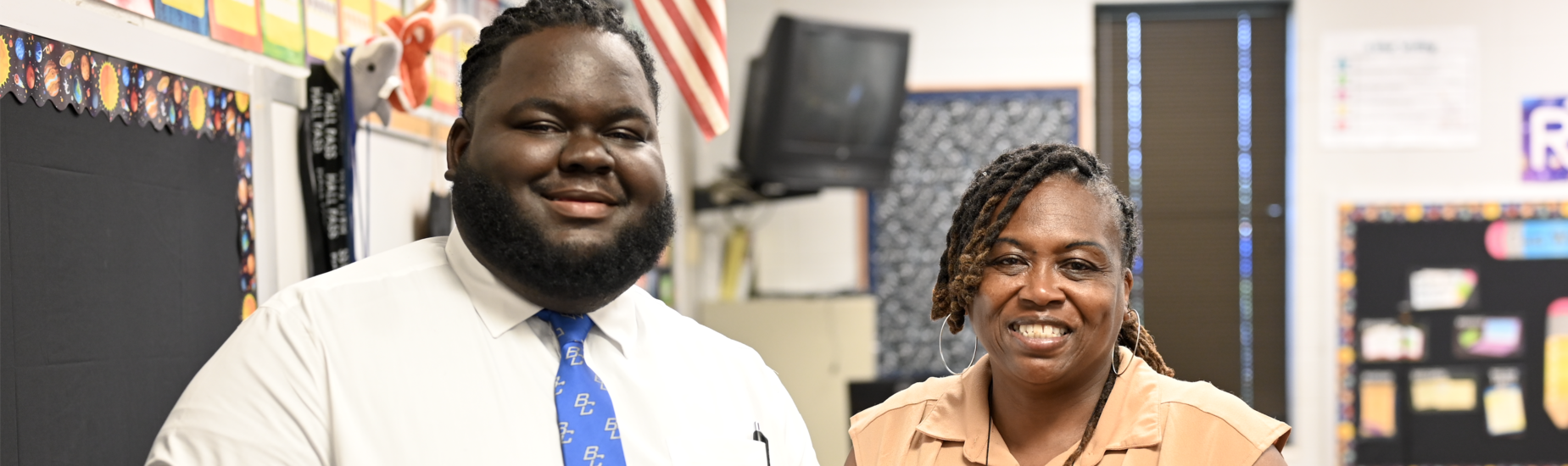 A second grade teacher and his paraprofessional at open house