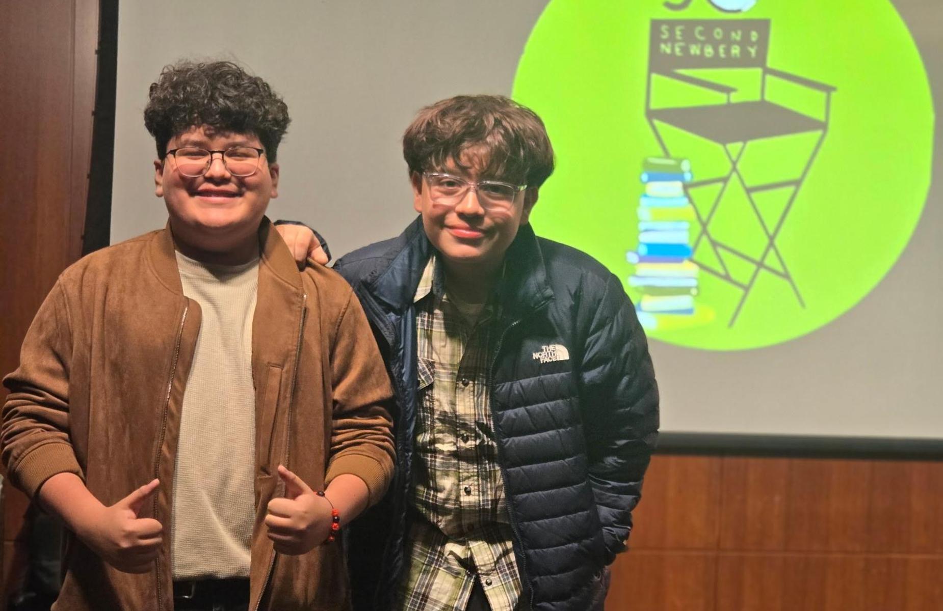 two students in front of screen