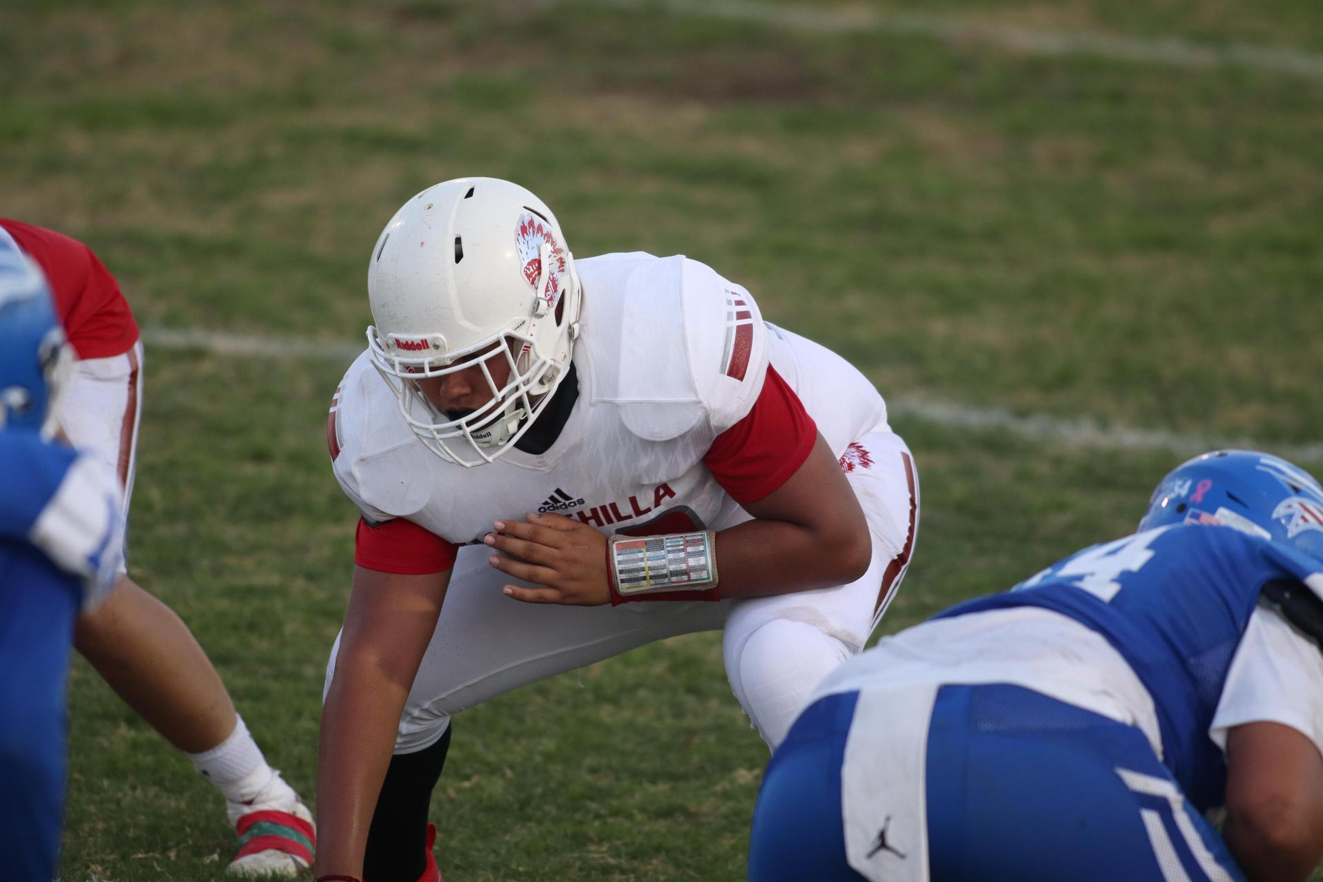 Junior Varsity football players in action against Caruthers