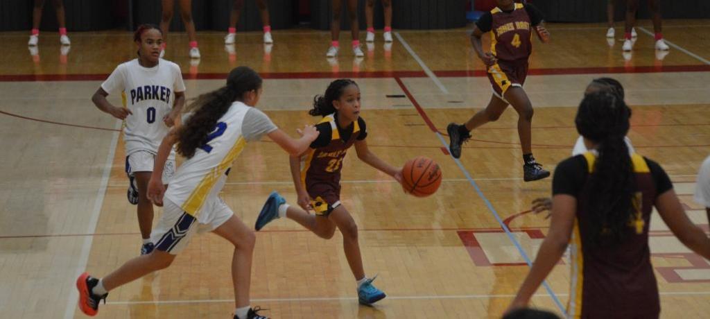 girl dribbles past defender