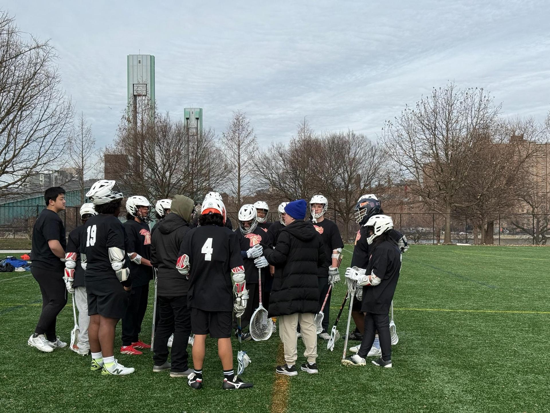 Lacrosse team huddling during a game.