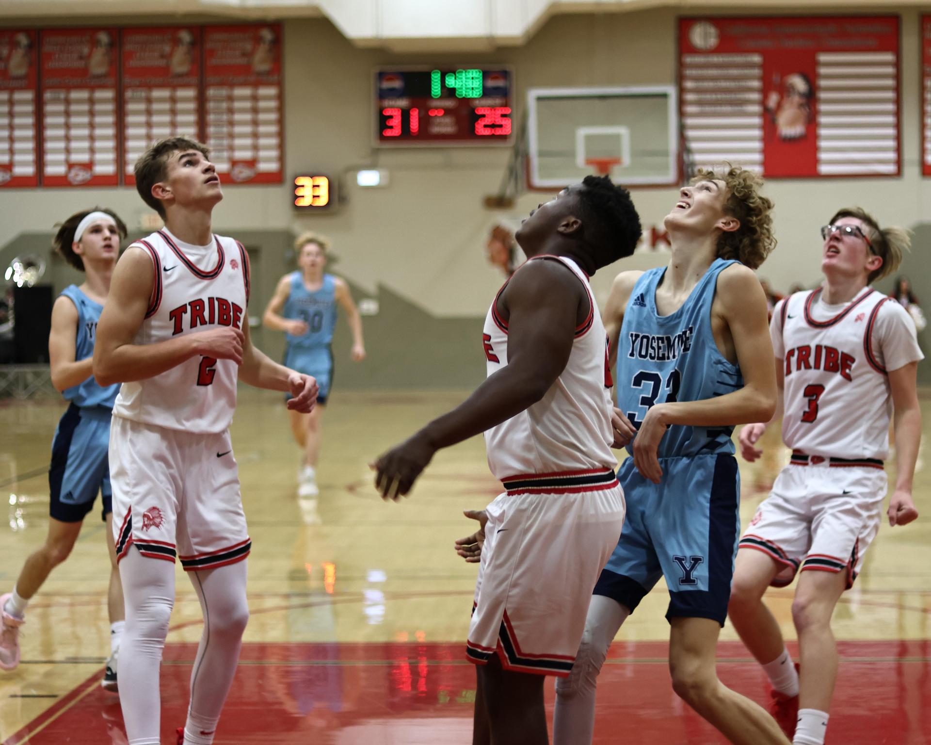 Varsity boys playing basketball against yosemite