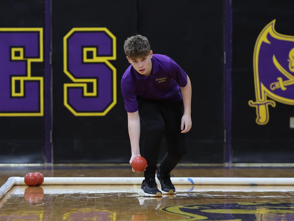 A Unified Bocce athlete about to throw a red ball.
