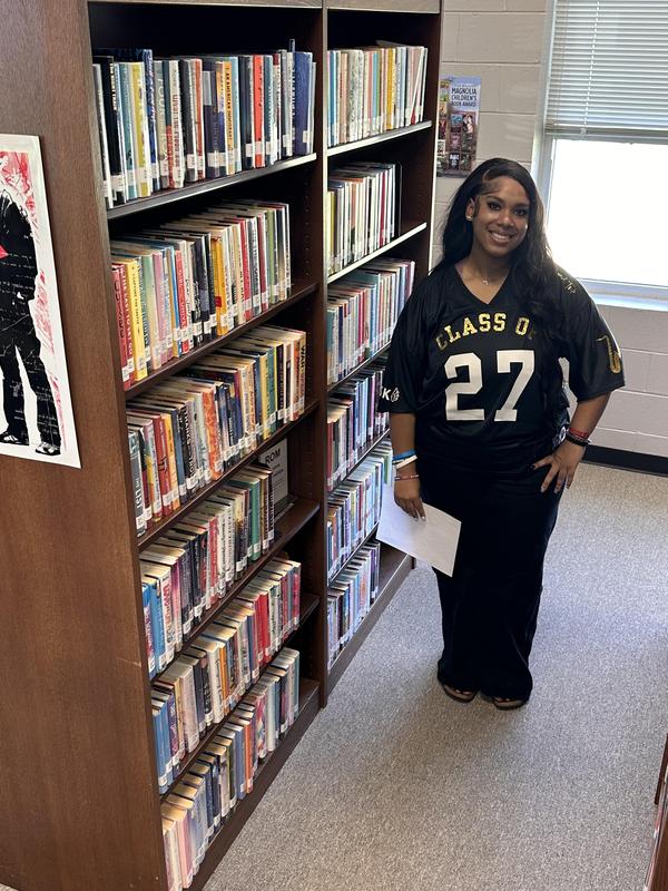 Janice smiling in the library stacks