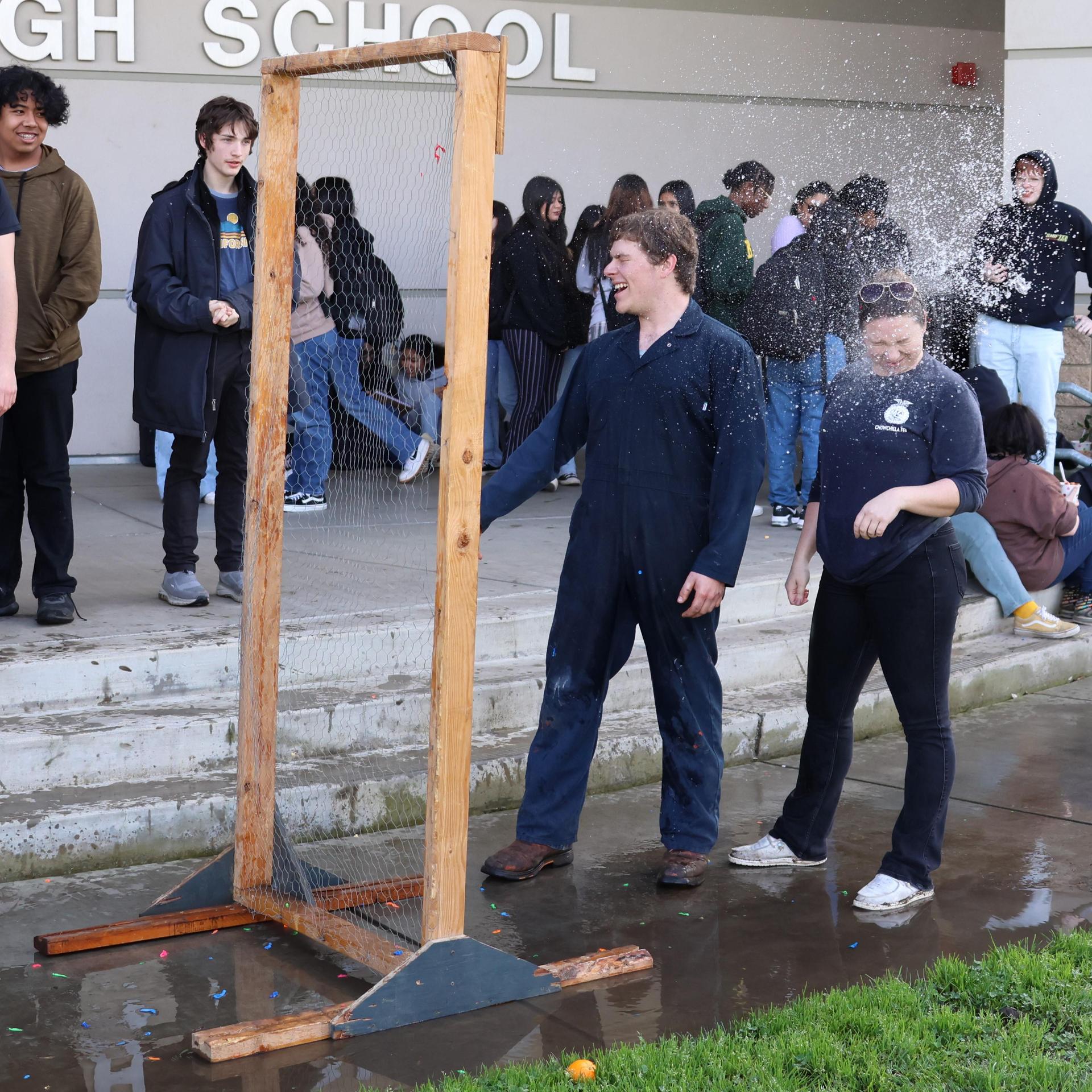 students and staff enjoying the water balloon toss