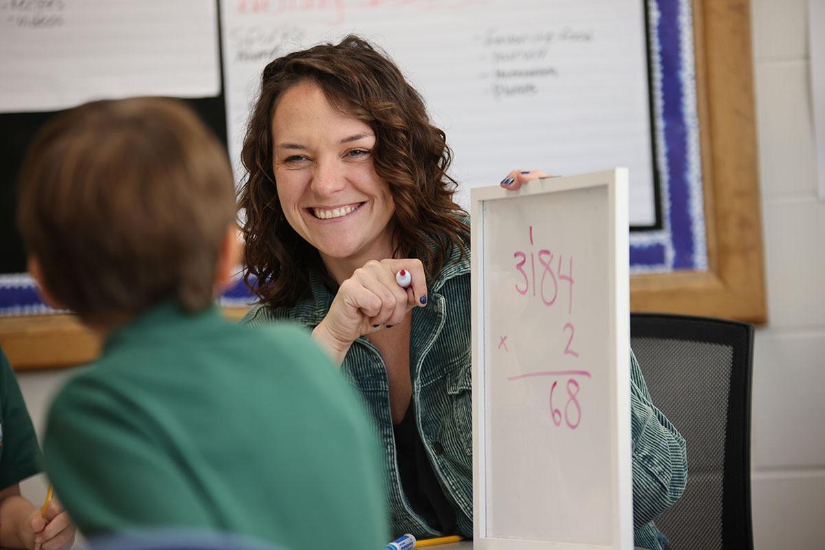 HSA Des Moines teacher and student working together with a whiteboard and marker