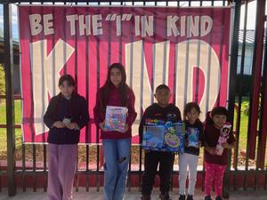 Students holding a toy