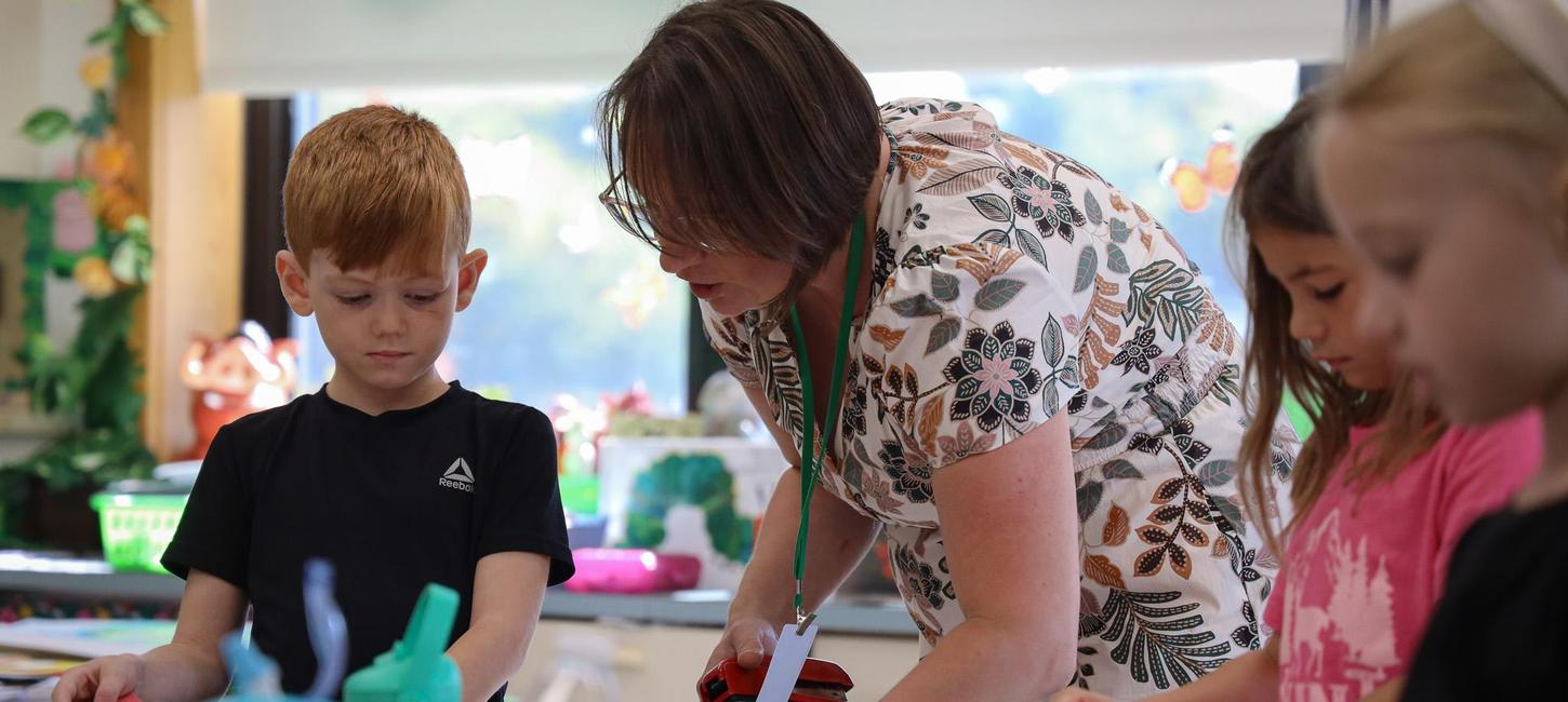 Teacher helping students