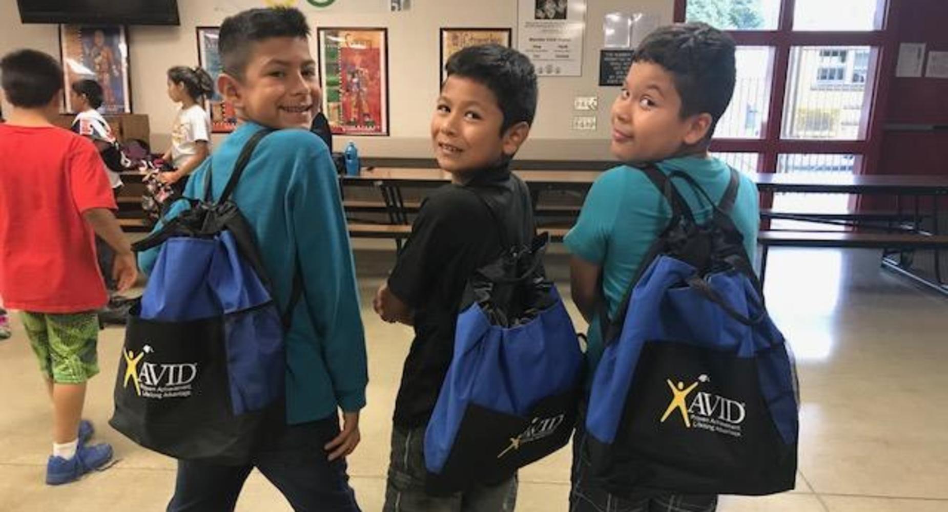 3 boys wearing their AVID backpacks.