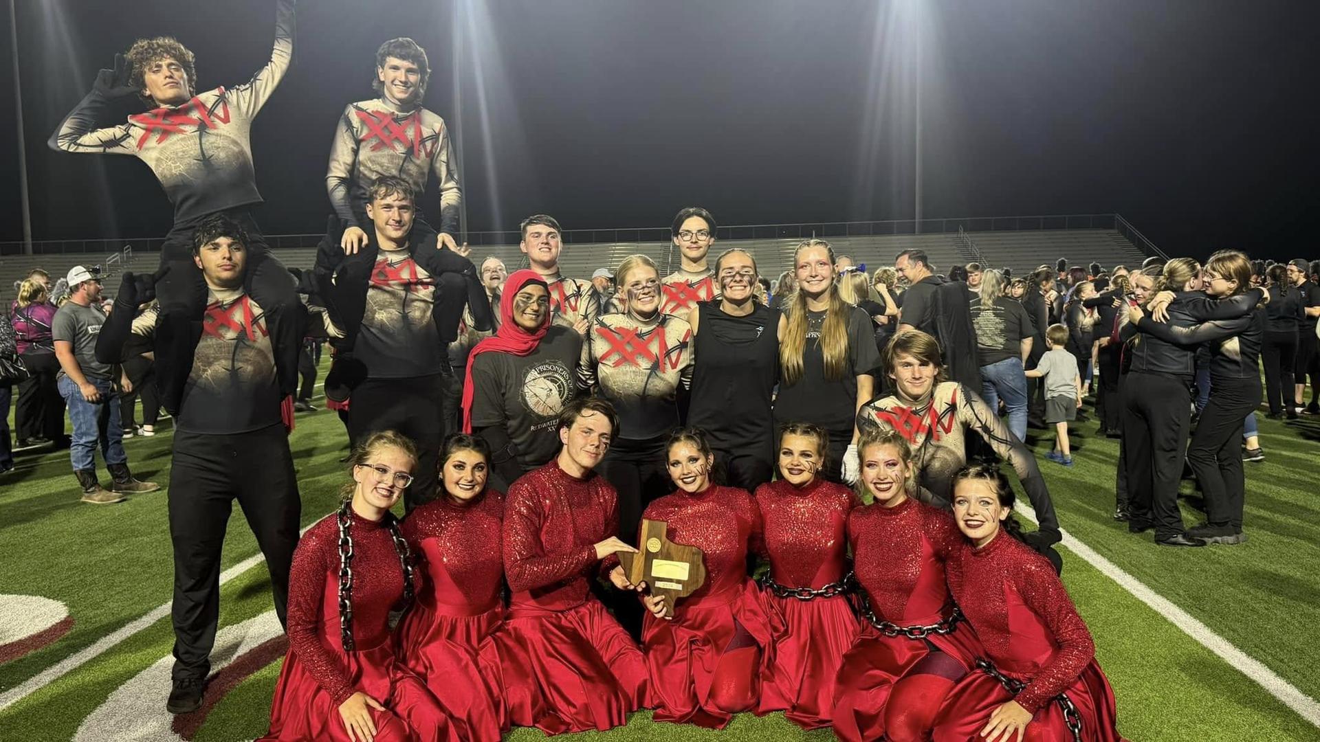 Colorguard and band members pose for photo