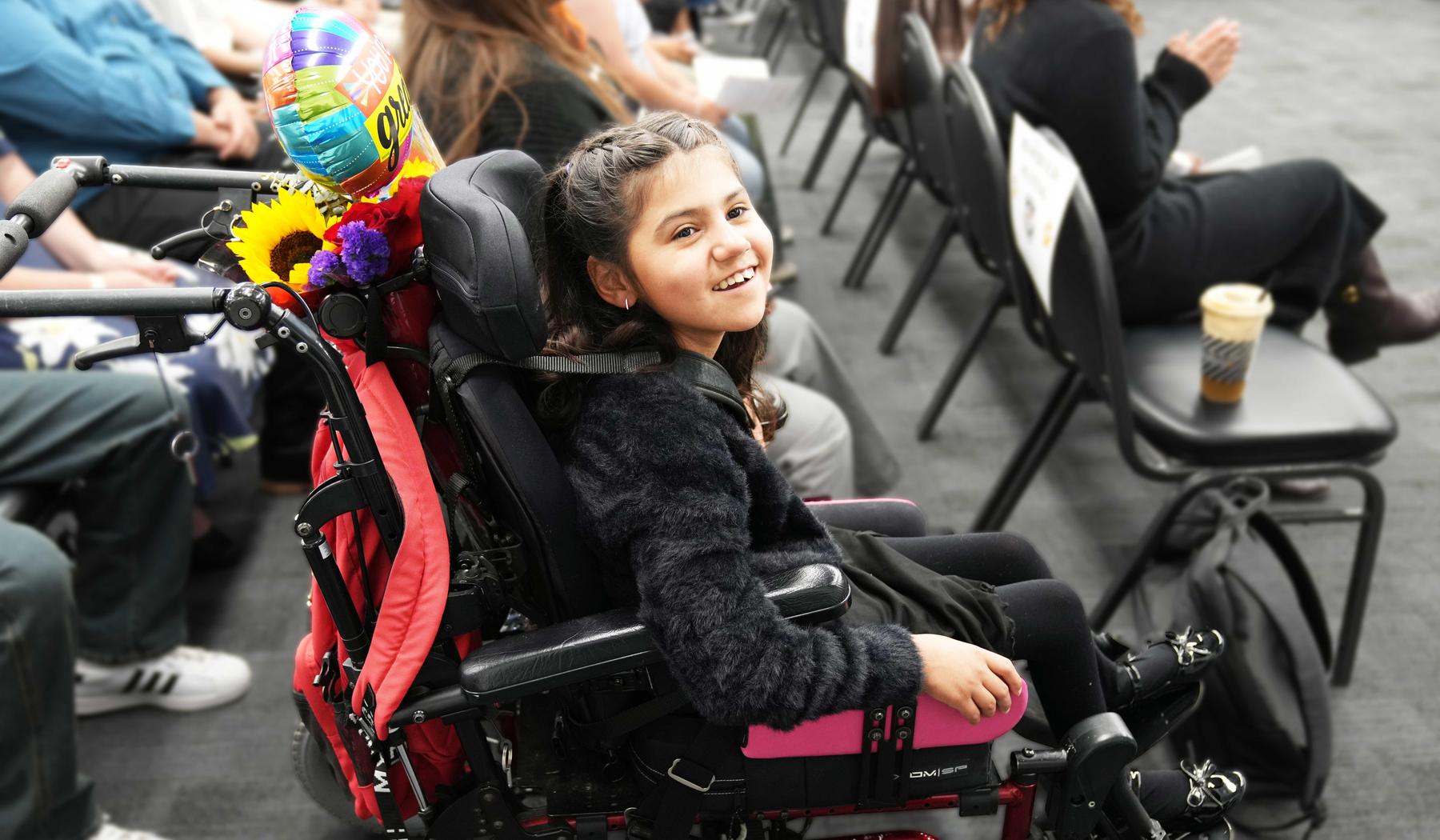 Smiling girl in a wheelchair