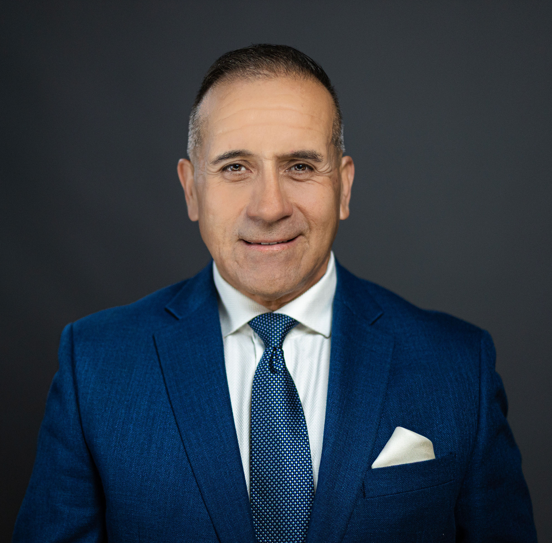 Man in blue suit smiling