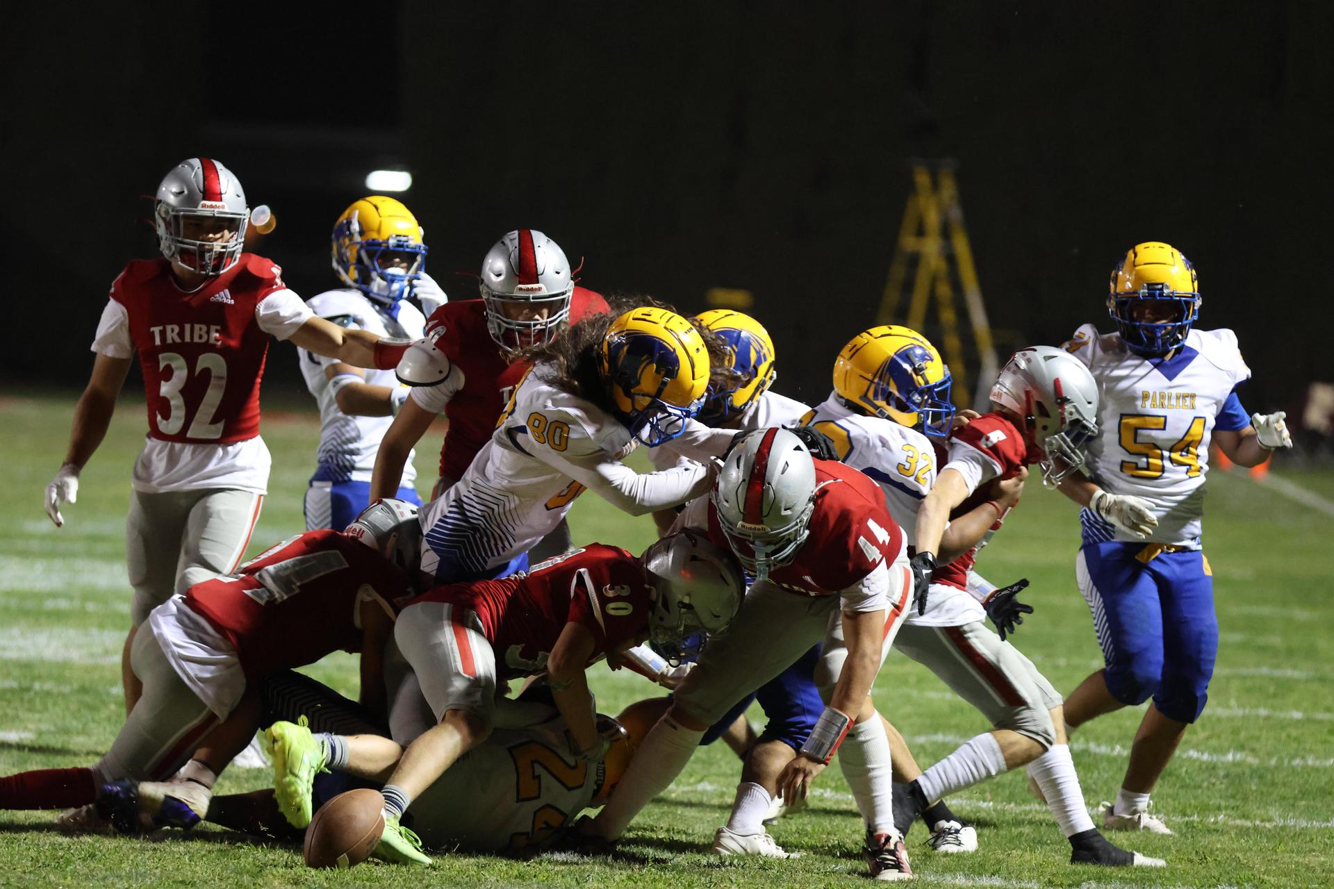 Varsity football players in action against Parlier 31