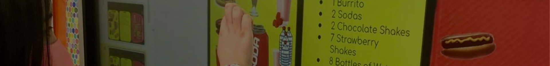 Menu items displayed on colorful boards including food options like burritos and snacks.