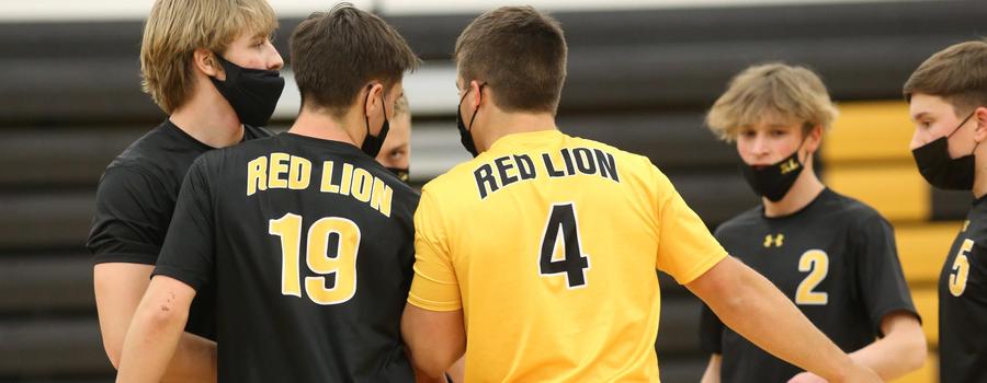 Boys Volleyball team talks strategy before a game