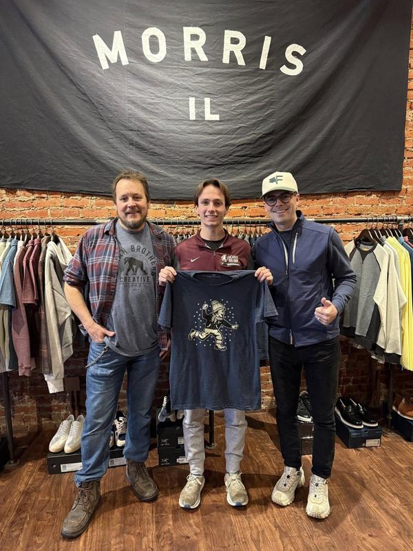 student holding shirt