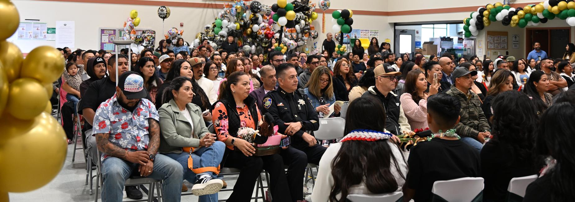 Parents attending promotion ceremony with balloons