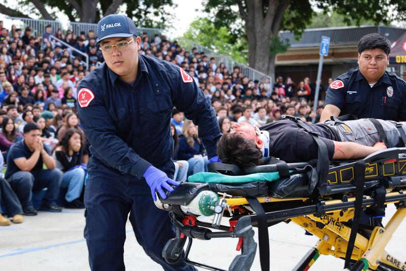 Emergency responders transport a Santa Fe High School student to an ambulance during a staged car crash simulation on April 1.