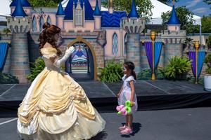 Belle greets a child at 70 Happiest Hours.