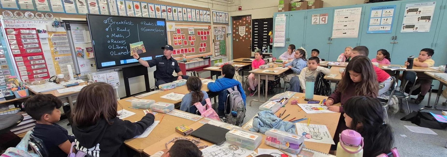 Firefighter reading to students for Read across America