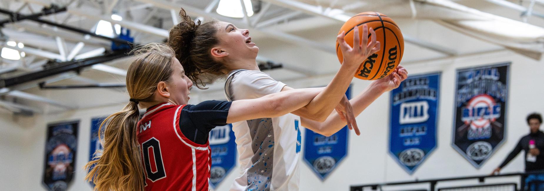 A female basketball player is fouled