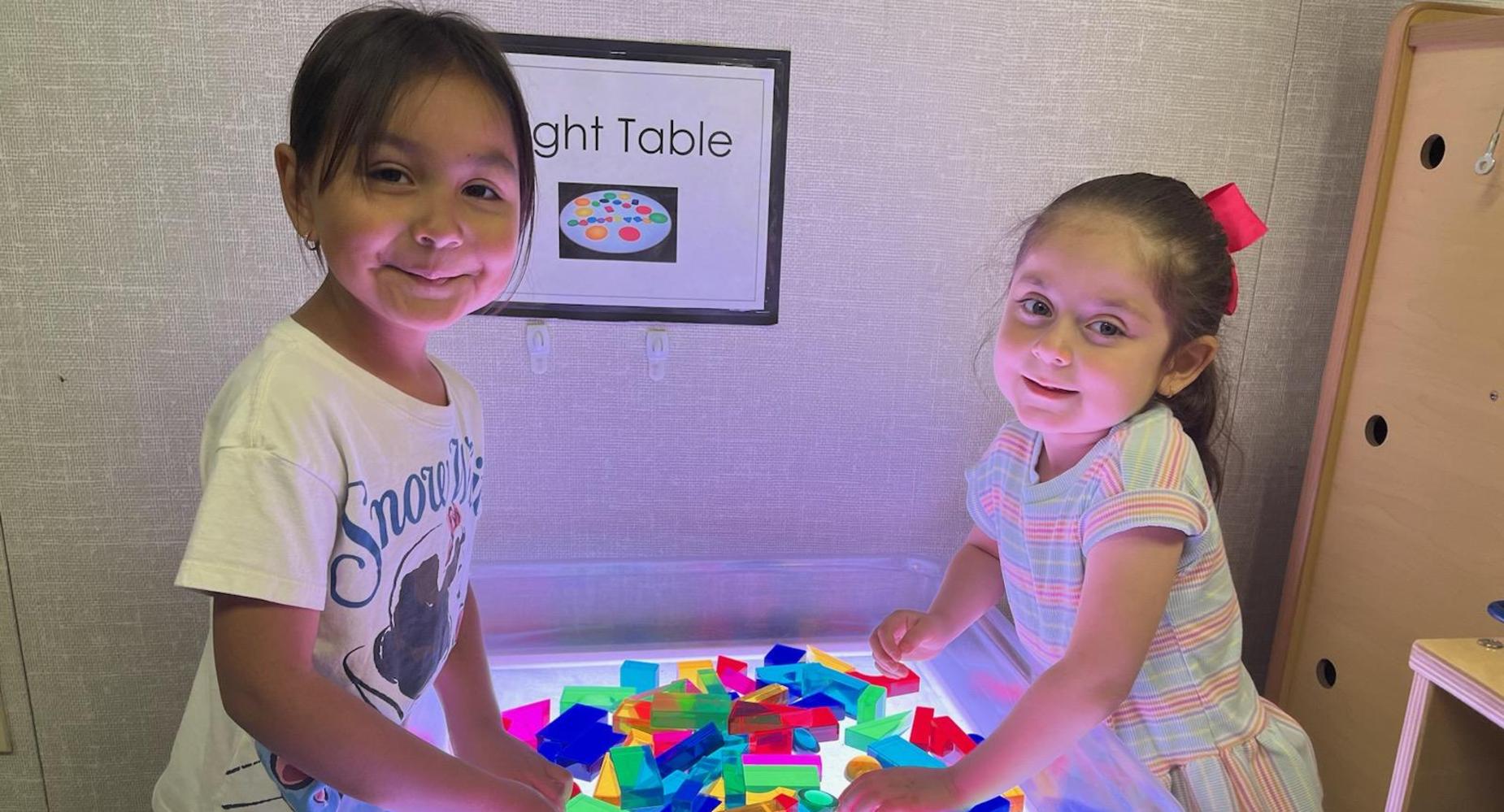 Children experiencing the light table