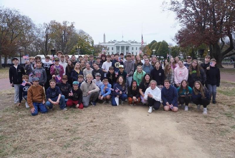 large group of students in front of white house