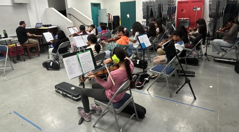 Students playing their instruments in their classroom