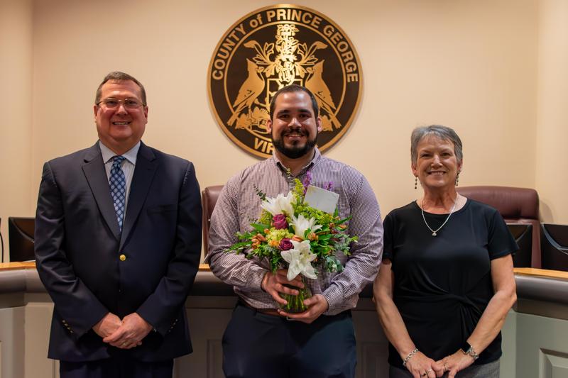 Dr. Wayne Lyle, Superintendent, Mr. Morris Lawson, Division teacher of the year, and Mrs. Jill Andrews, Chair of the Prince George School Board are featured.