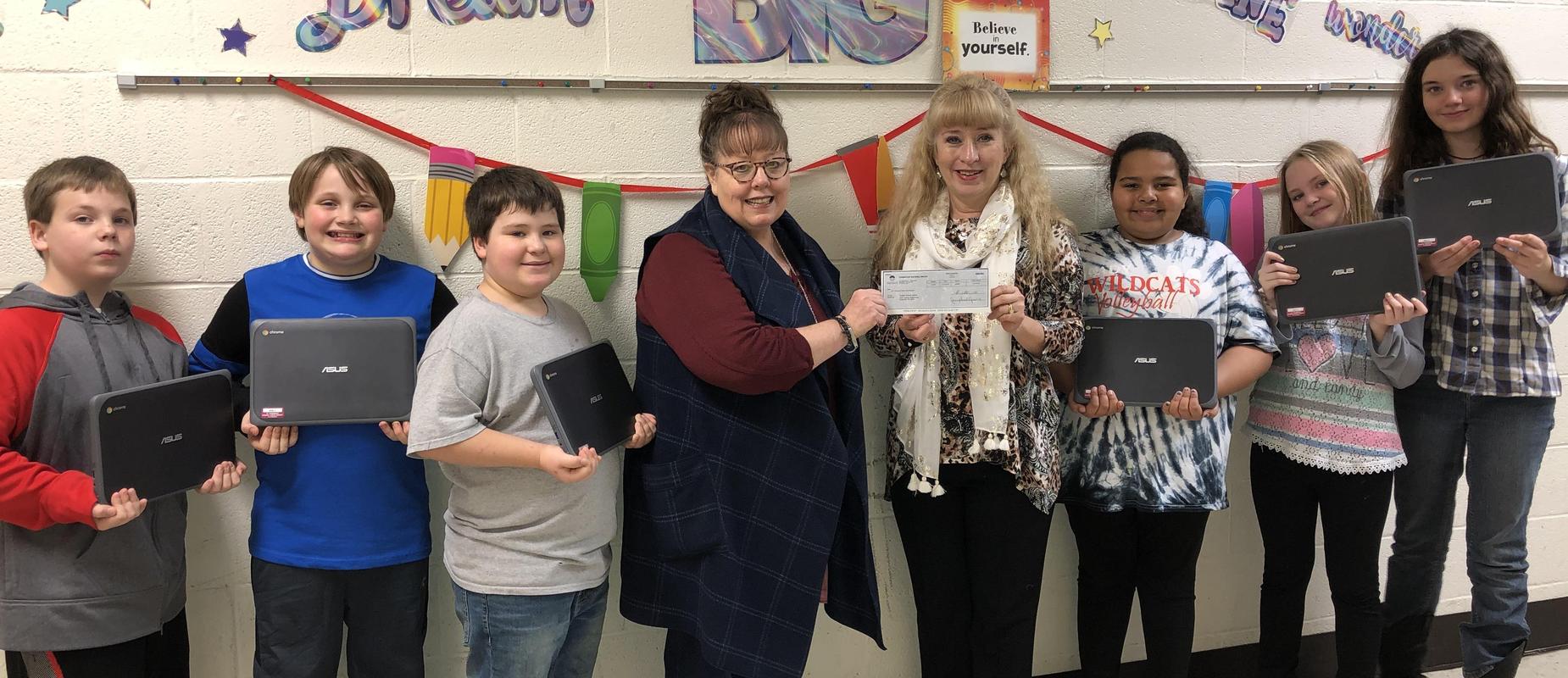students with teachers with check for reward for chrome books