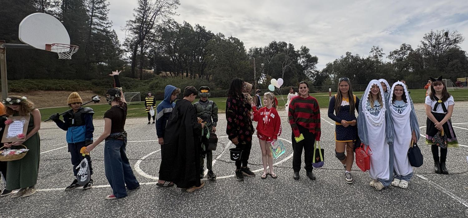 Students parade on the playground in Halloween costumes