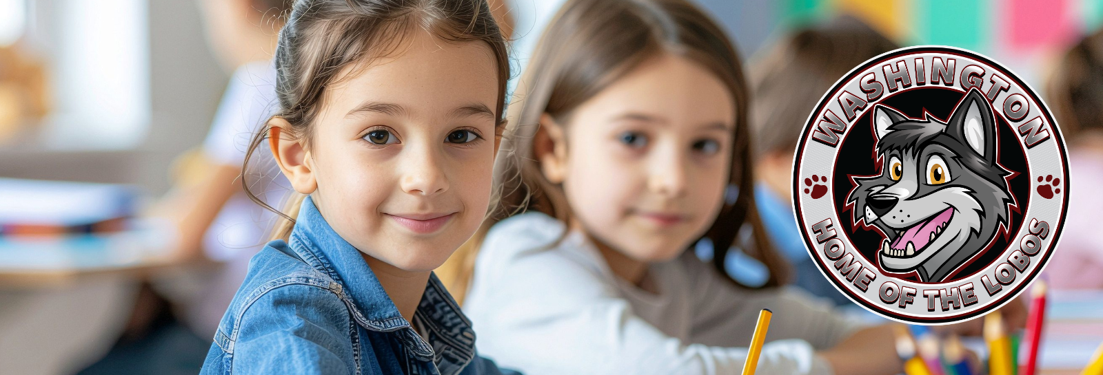 Washington ES shuffle image for homepage - students sitting at a desk smiling