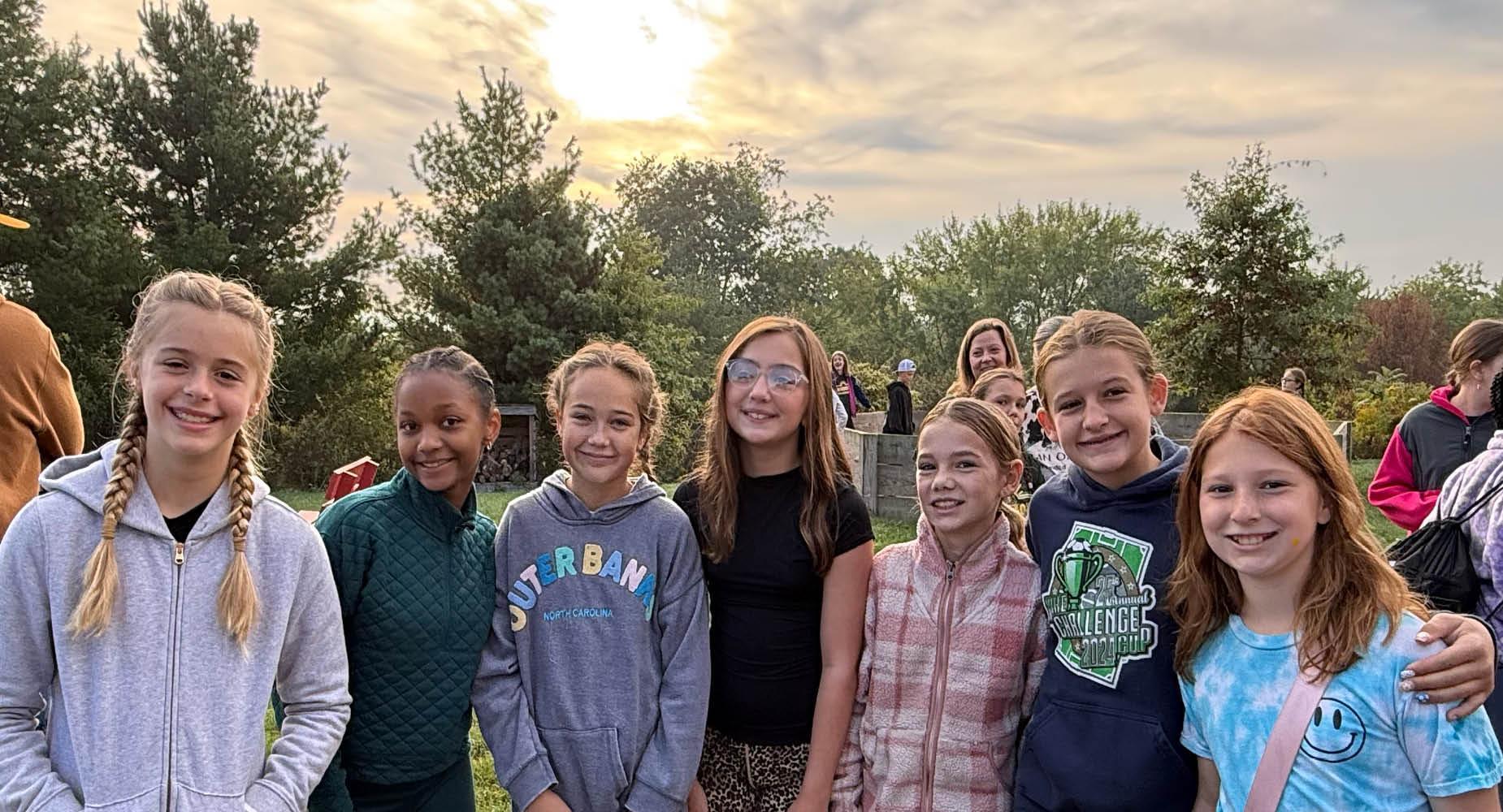 A group of 5th-grade students gathers at Deer Valley Camp to enjoy a sunset