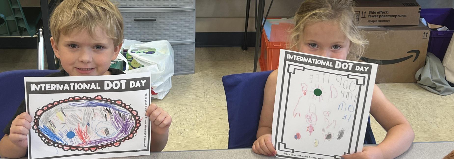 boy and girl showing the pictures they drew
