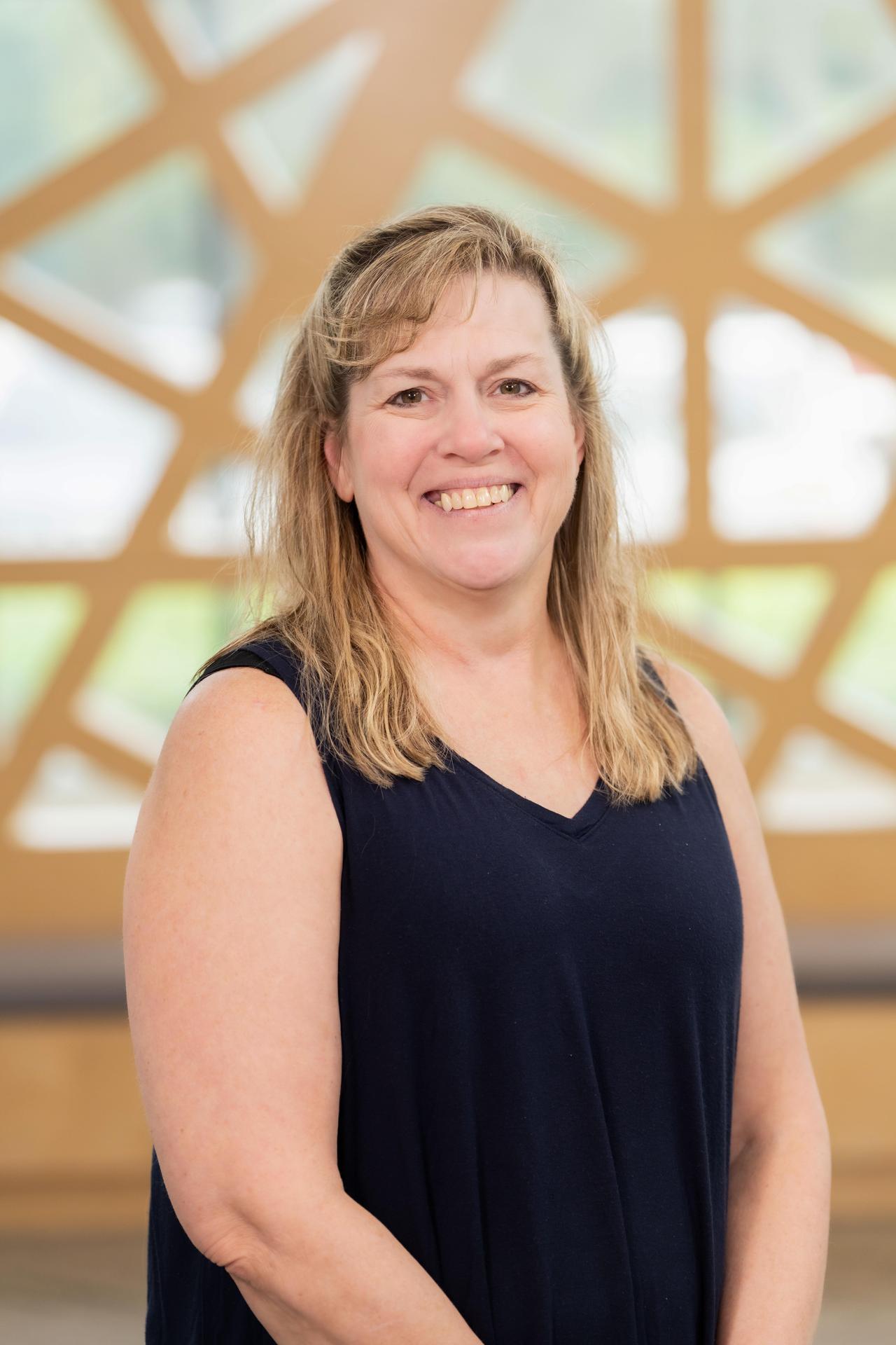 Blonde lady with bangs smiling