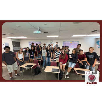 Photo of a group of students in a classroom with a teacher