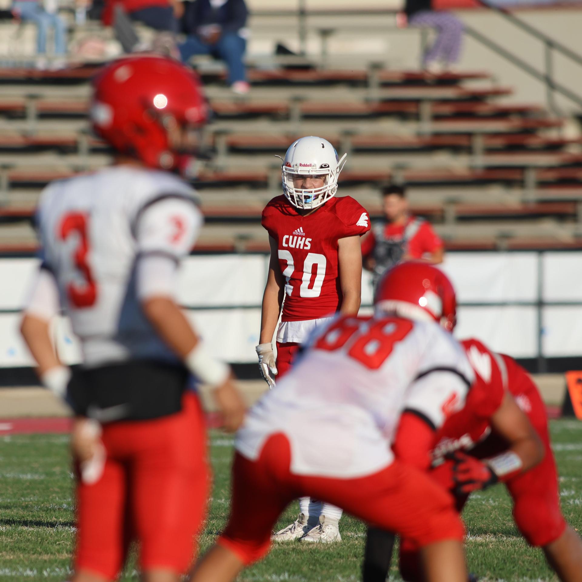 junior varsity football players in action against Fowler