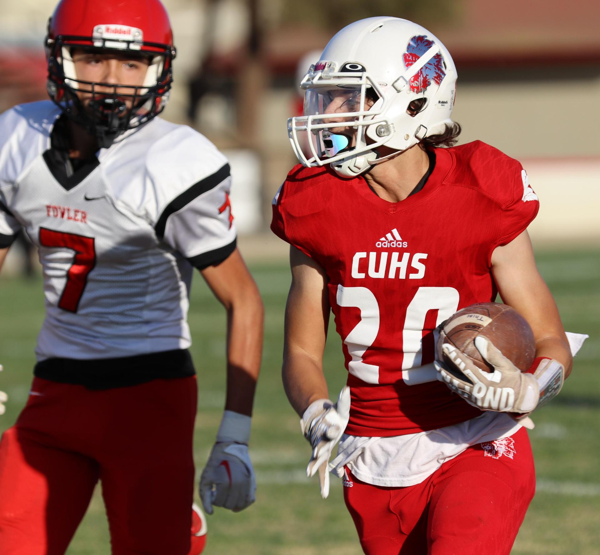 junior varsity football players in action against Fowler