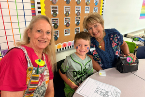 Two grandmothers with student at Crestview grandparents event