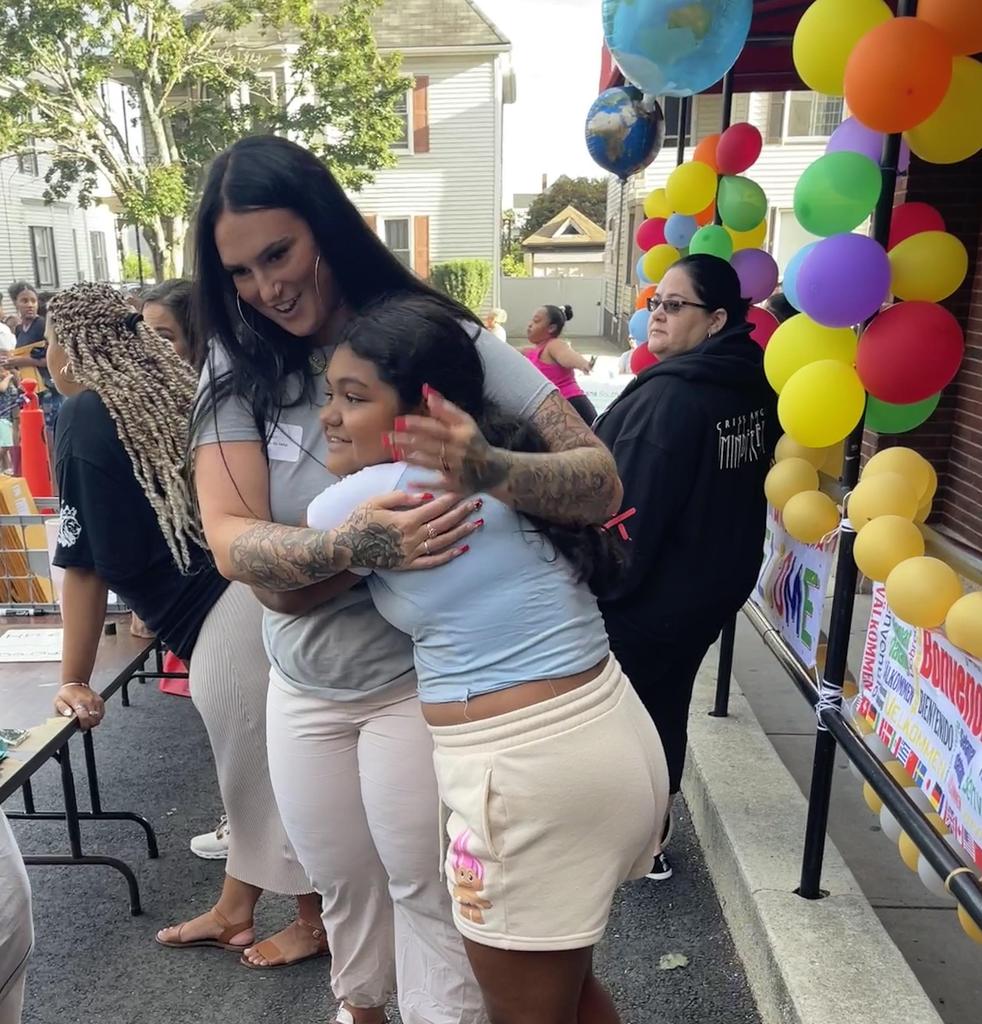 student hugging teacher