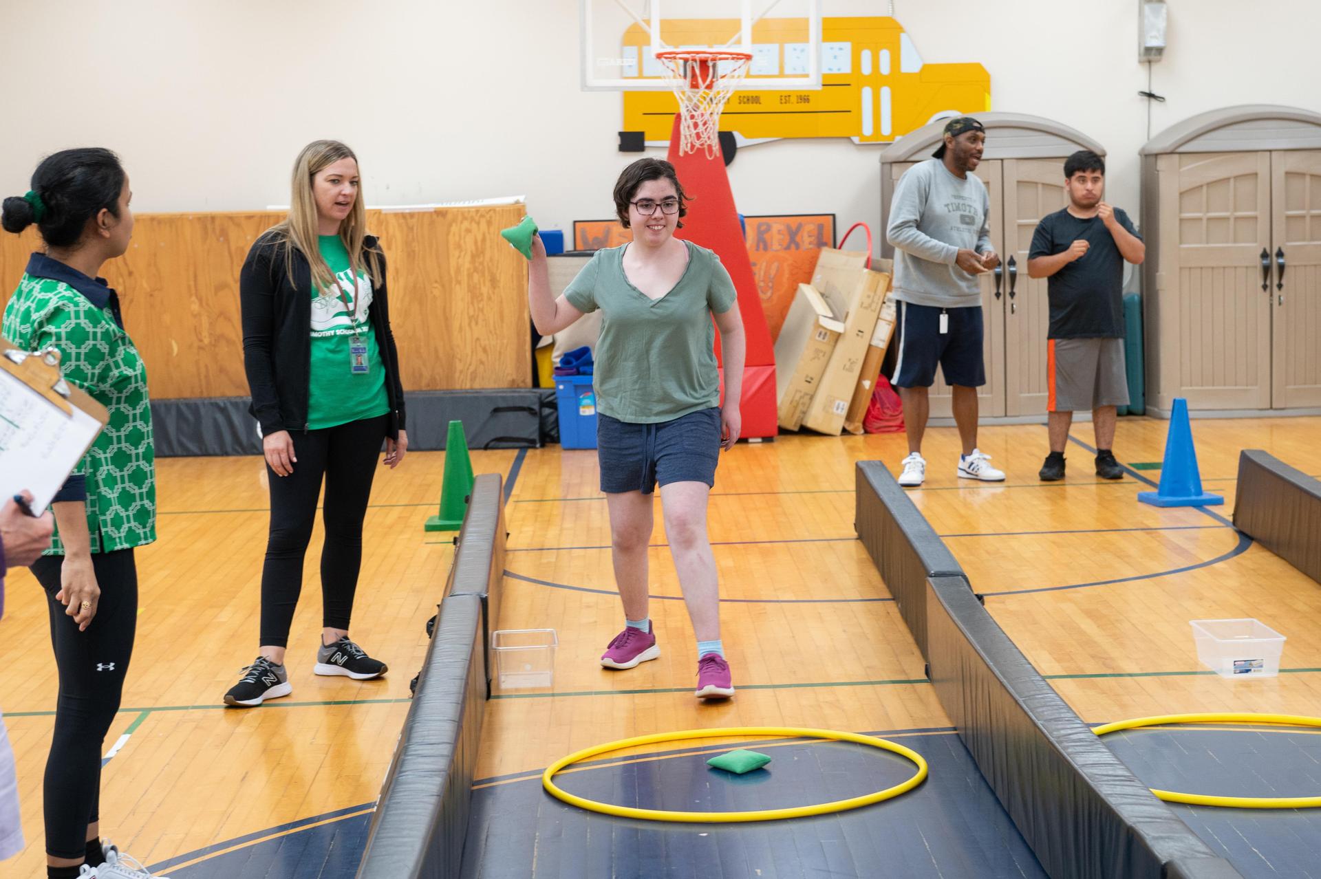 Group of participants engaging in an indoor activity with colorful equipment.