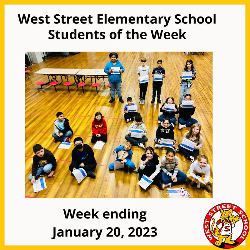 A photo of elementary school students with certificates of achievement