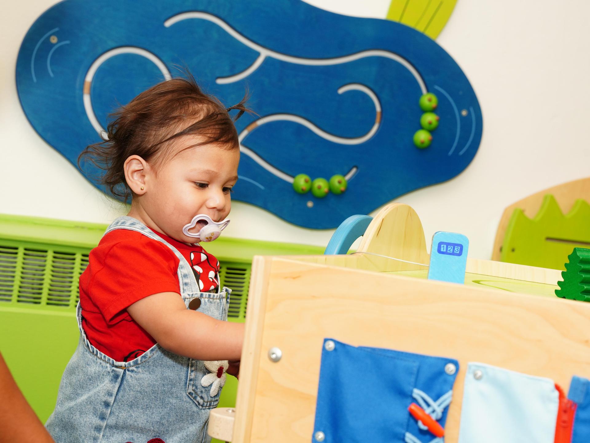 A toddler playing in the clinic's play area.
