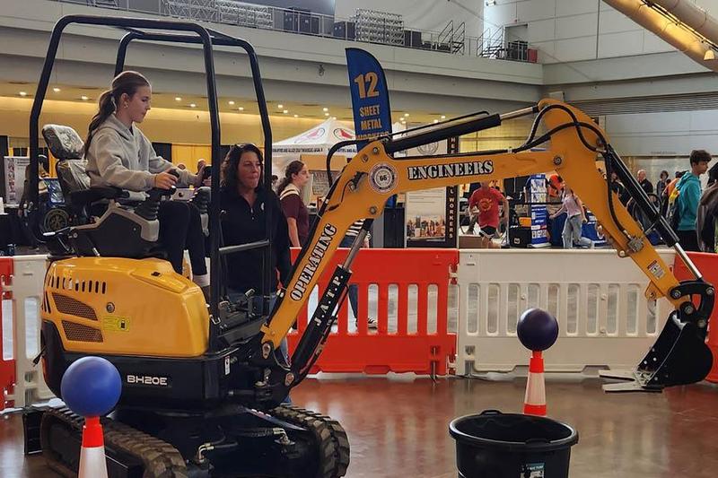 Laney Rosenberry learns how to operate an excavator