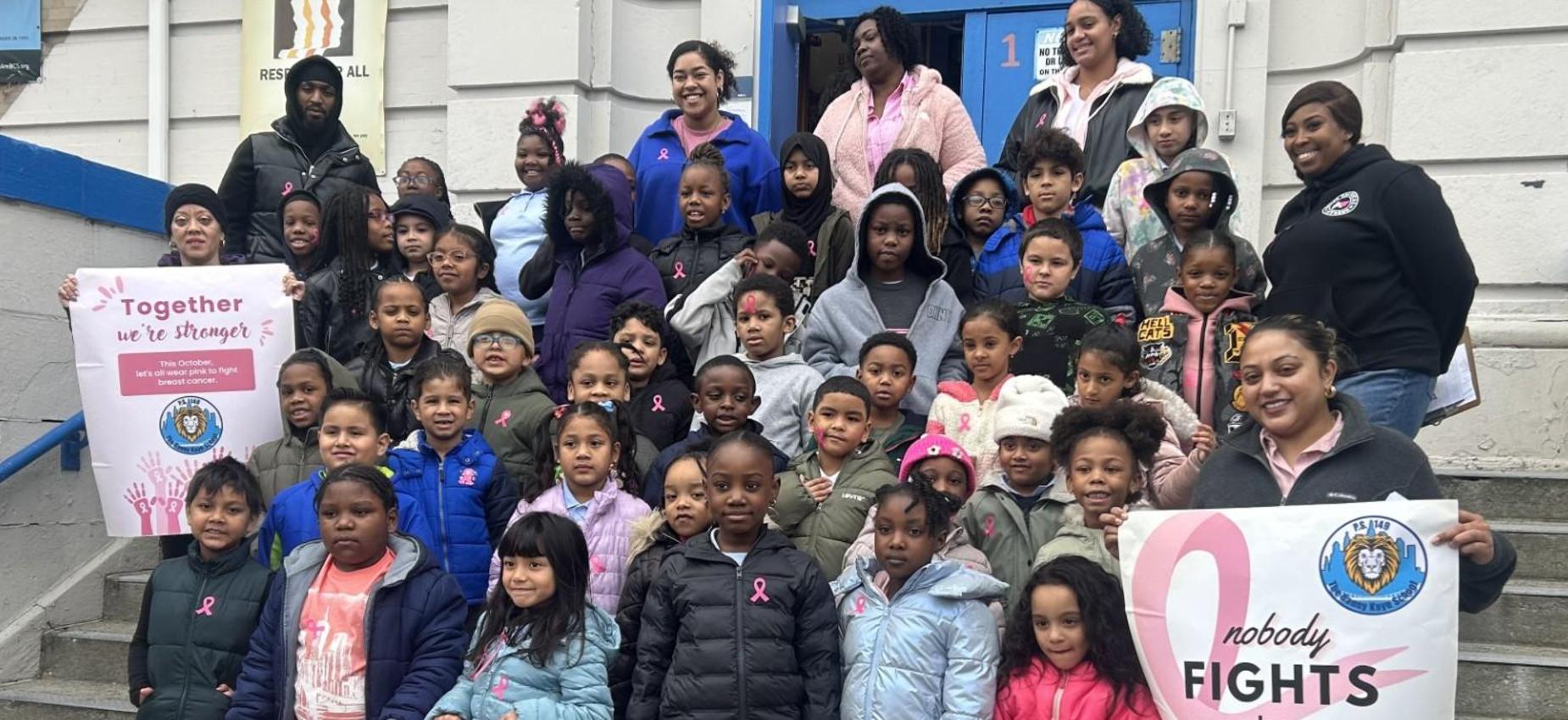 class photo in front of school for breast cancer awareness