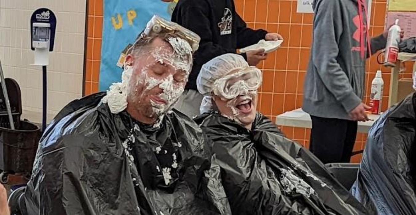 Teachers take a pie in the face to help raise funds for charity.